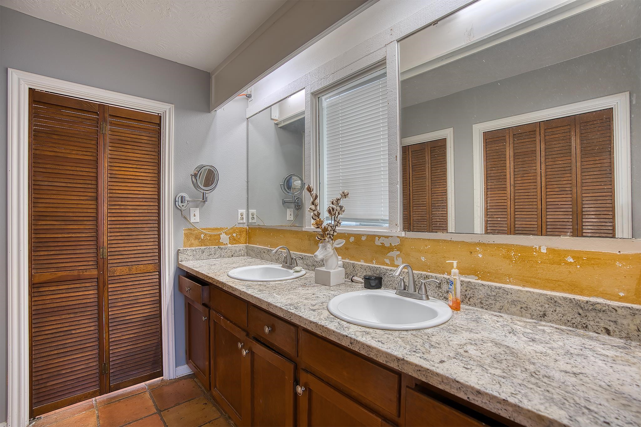 7476 Foard Road Beaumont, TX 77705 - Photo 36 of 49 a bathroom with a granite countertop sink and a mirror