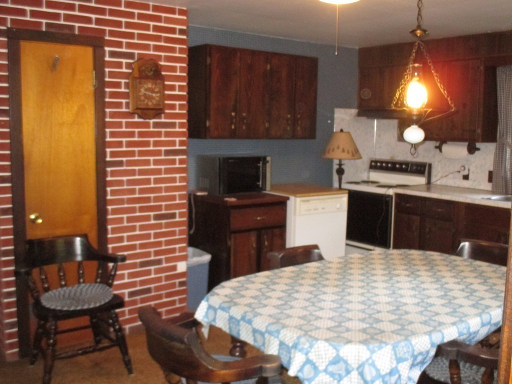 172 Ellis Road Westminster, MA 01473 - Photo 6 of 18 a kitchen with stainless steel appliances kitchen island granite countertop a stove a sink a dining table and chairs