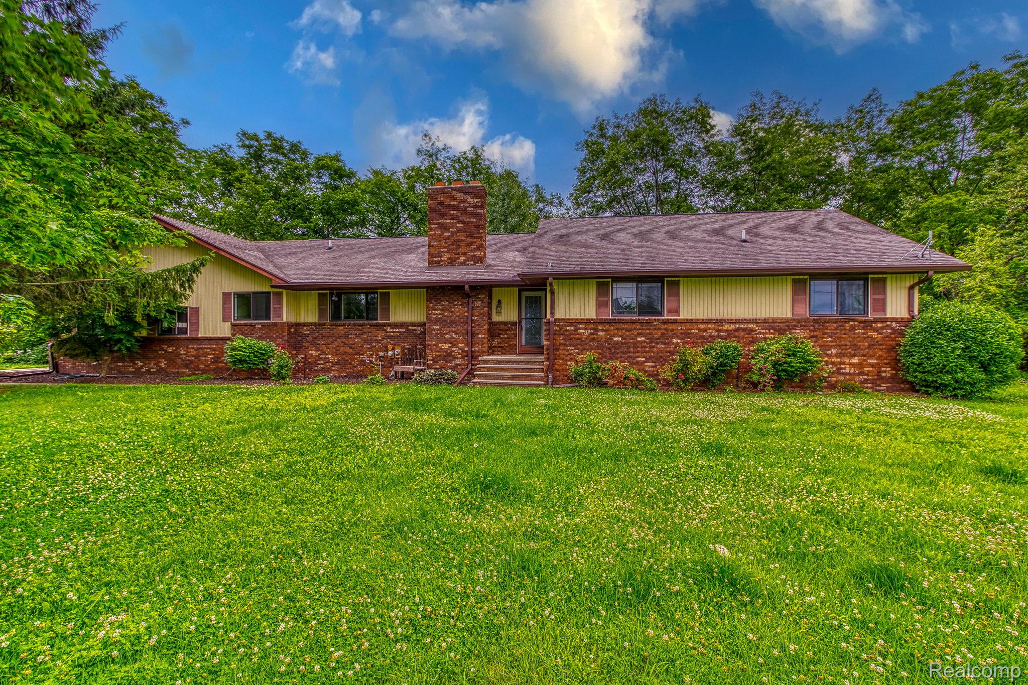 12012 Belle River Road Memphis, MI 48041 - Photo 1 of 41 Ranch-style house featuring a chimney, a front lawn, and brick siding