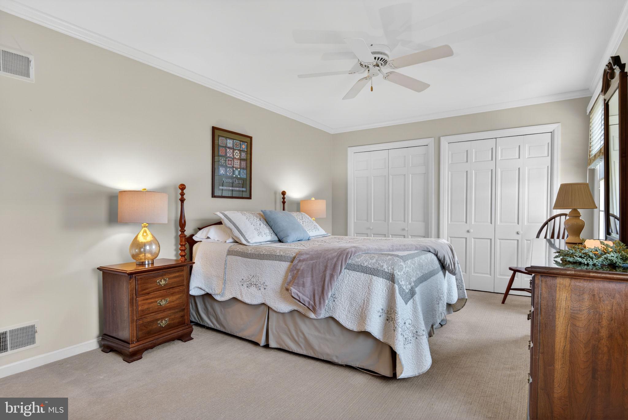 441 Trena Avenue Lancaster, PA 17601 - Photo 34 of 61 a spacious bedroom with a bed and a lamp on the dresser