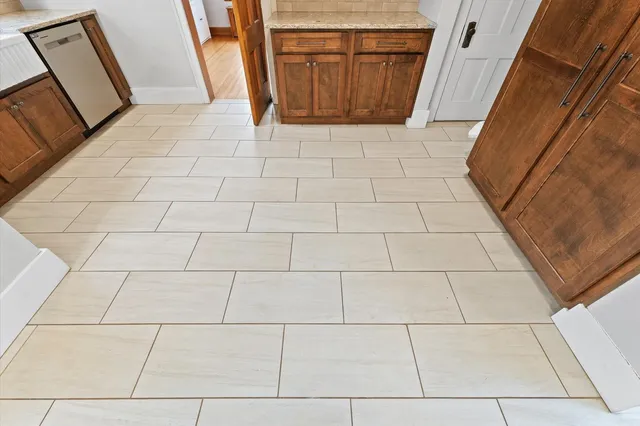 a view of a room with wooden floor and windows