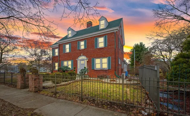 a front view of a house with a garden