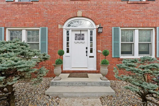 a front view of a house with a garden