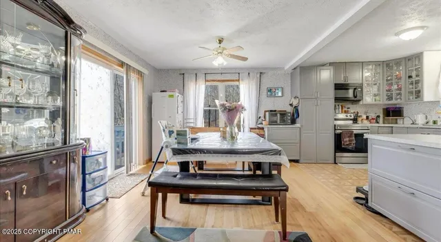 a open kitchen with stainless steel appliances granite countertop a stove refrigerator and cabinets