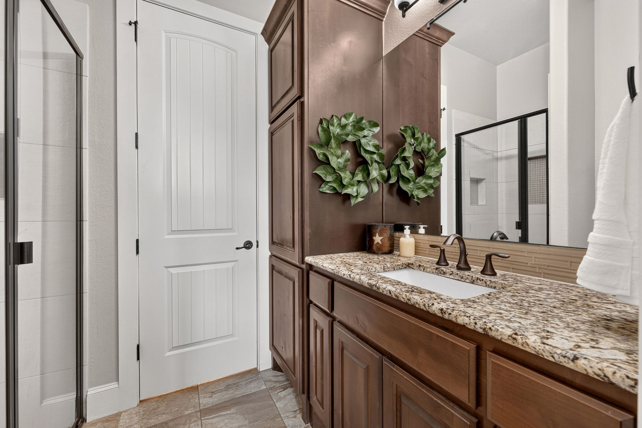 105 Coopers Hill Road Georgetown, TX 78633 - Photo 30 of 40 a bathroom with a granite countertop sink and a mirror