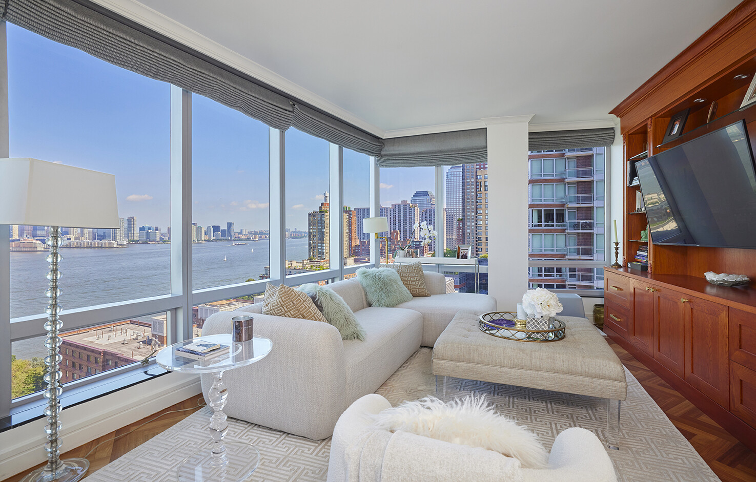 10 West Street, Unit 18A Manhattan, NY 10004 - Photo 2 of 11 a living room with furniture and a flat screen tv