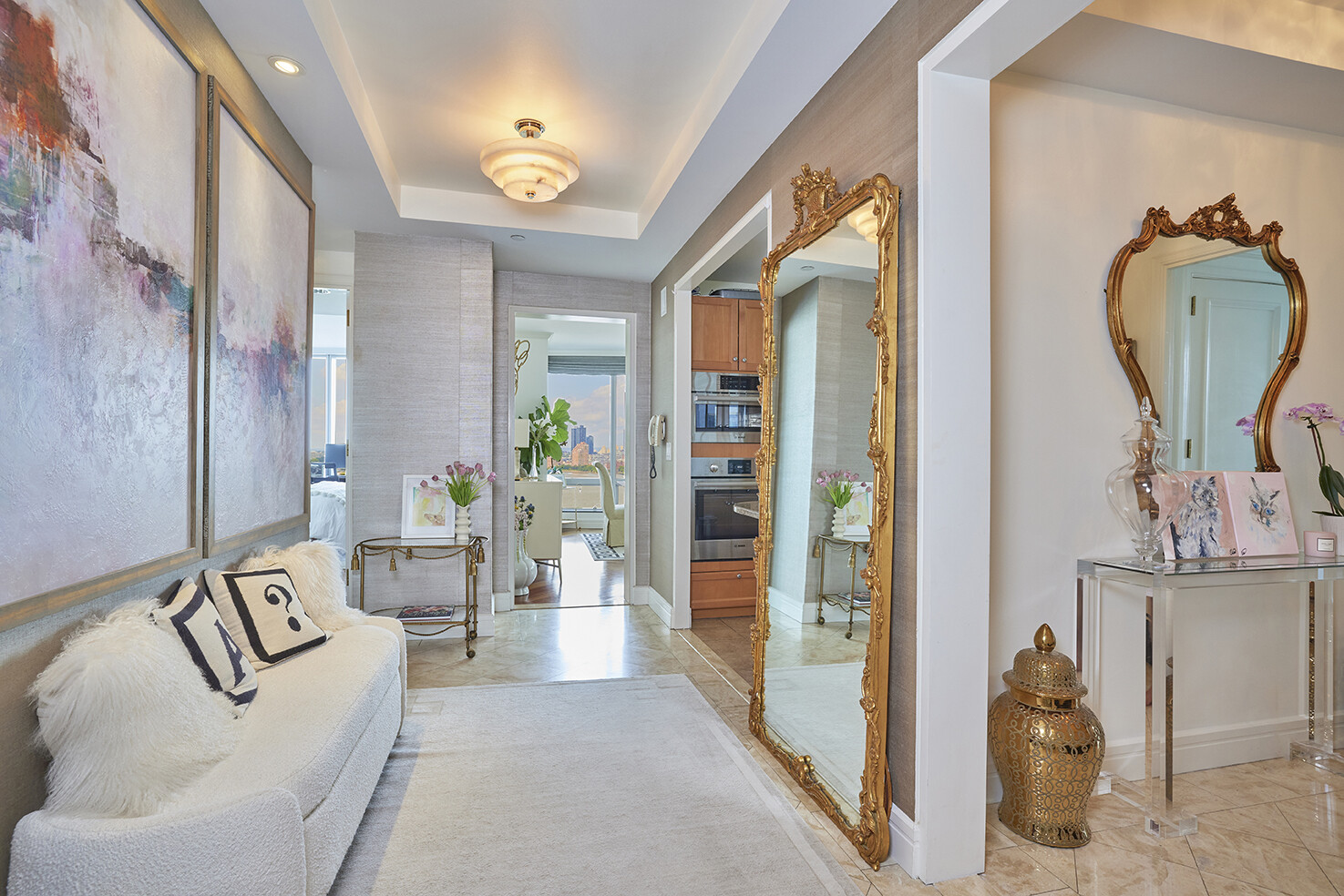 10 West Street, Unit 18A Manhattan, NY 10004 - Photo 3 of 11 a living room with furniture and a mirror
