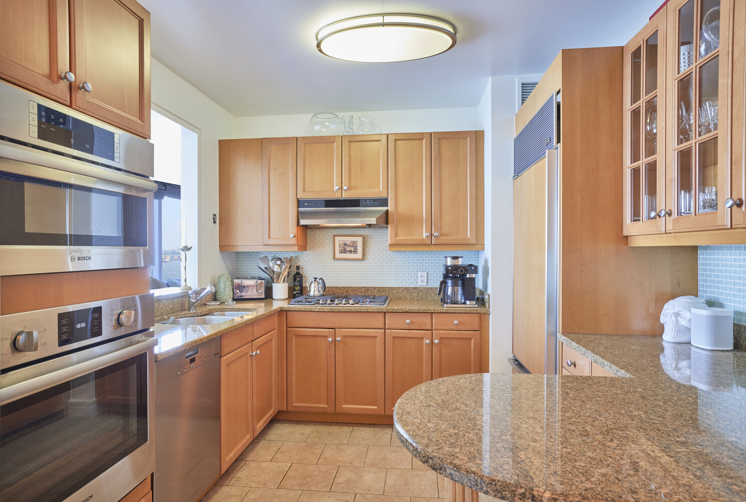 10 West Street, Unit 18A Manhattan, NY 10004 - Photo 4 of 11 a kitchen with stainless steel appliances granite countertop a sink stove and cabinets