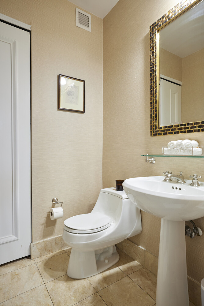 10 West Street, Unit 18A Manhattan, NY 10004 - Photo 7 of 11 a bathroom with a sink toilet and mirror