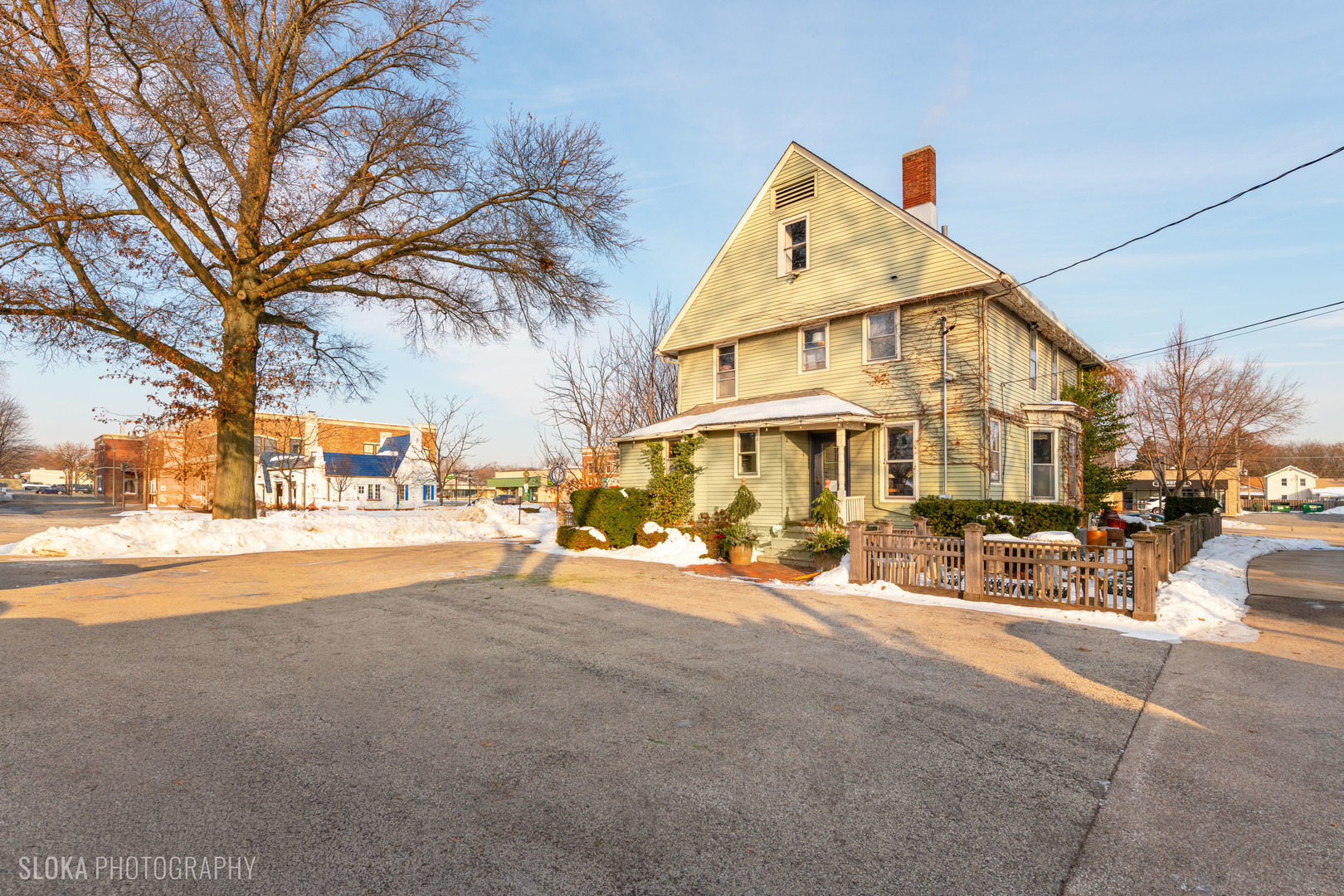 428 West State Street Geneva, IL 60134 - Photo 15 of 61 a view of a white house with a large tree and sitting area