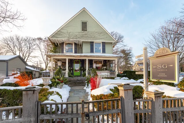 a front view of a building with cars parked