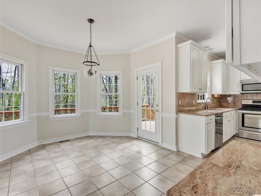 16219 Dragonnade Trail Midlothian, VA 23113 - Photo 17 of 39 a kitchen with granite countertop a stove a sink and a refrigerator