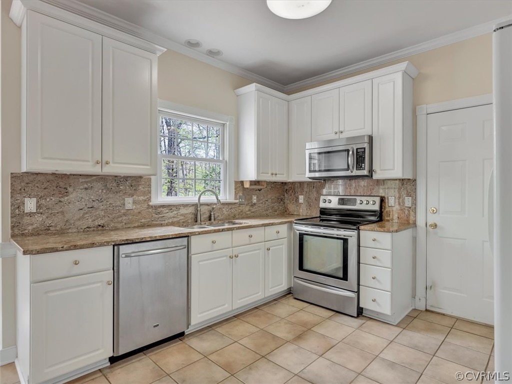 16219 Dragonnade Trail Midlothian, VA 23113 - Photo 18 of 39 a kitchen with cabinets appliances a sink and a window