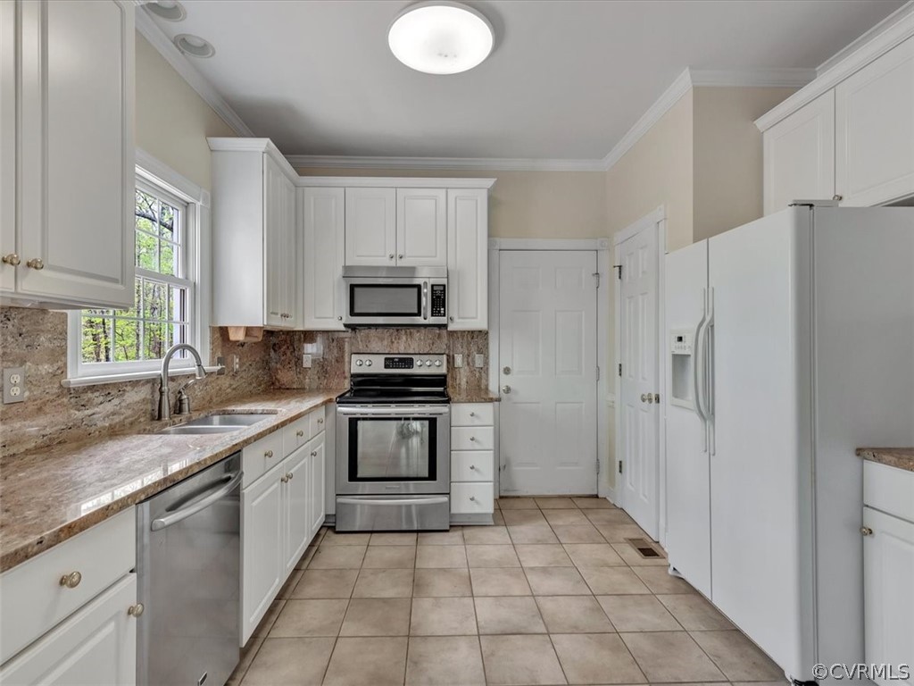 16219 Dragonnade Trail Midlothian, VA 23113 - Photo 19 of 39 a kitchen with stainless steel appliances granite countertop a refrigerator sink and stove