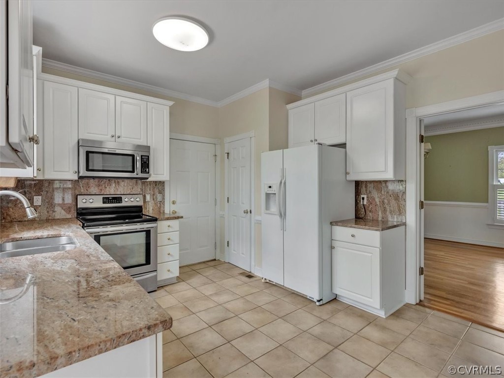 16219 Dragonnade Trail Midlothian, VA 23113 - Photo 20 of 39 a kitchen with white cabinets and stainless steel appliances