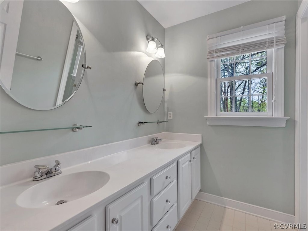 16219 Dragonnade Trail Midlothian, VA 23113 - Photo 32 of 39 a bathroom with a double vanity sink and a mirror