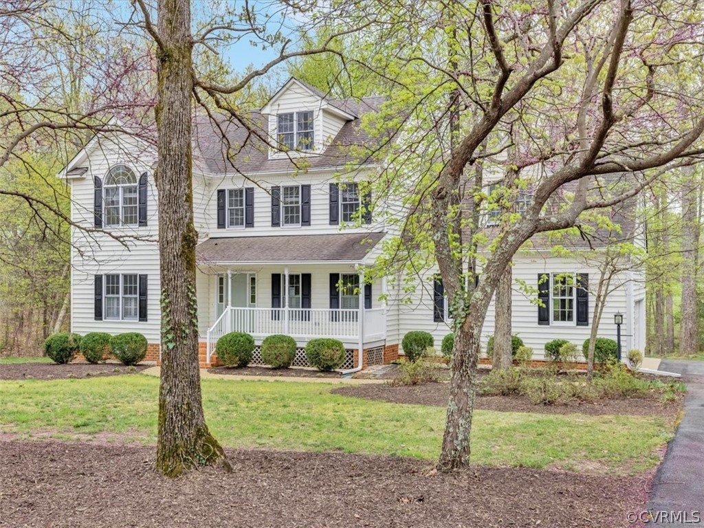 16219 Dragonnade Trail Midlothian, VA 23113 - Photo 4 of 39 a front view of a house with a yard and garage