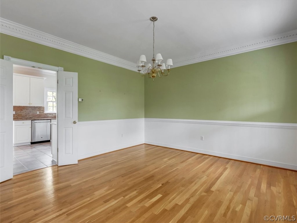 16219 Dragonnade Trail Midlothian, VA 23113 - Photo 8 of 39 a view of a room with wooden floor and a chandelier