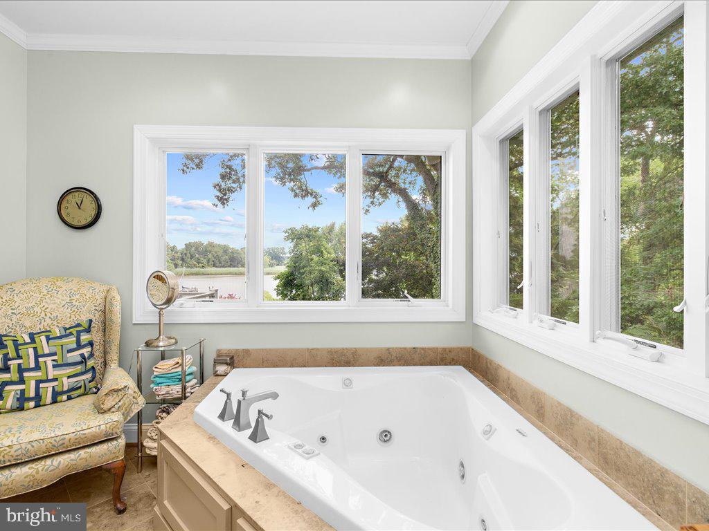 720 Southeast Creek Road Church Hill, MD 21623 - Photo 13 of 53 a bathroom with a bathtub and a window