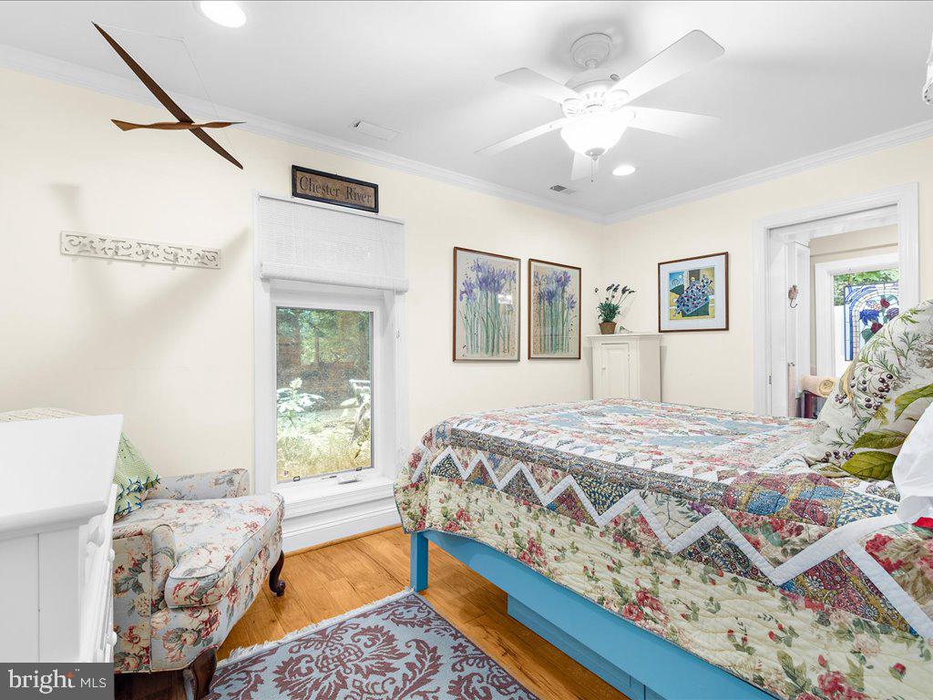 720 Southeast Creek Road Church Hill, MD 21623 - Photo 23 of 53 a bedroom with a bed dresser and wooden floor