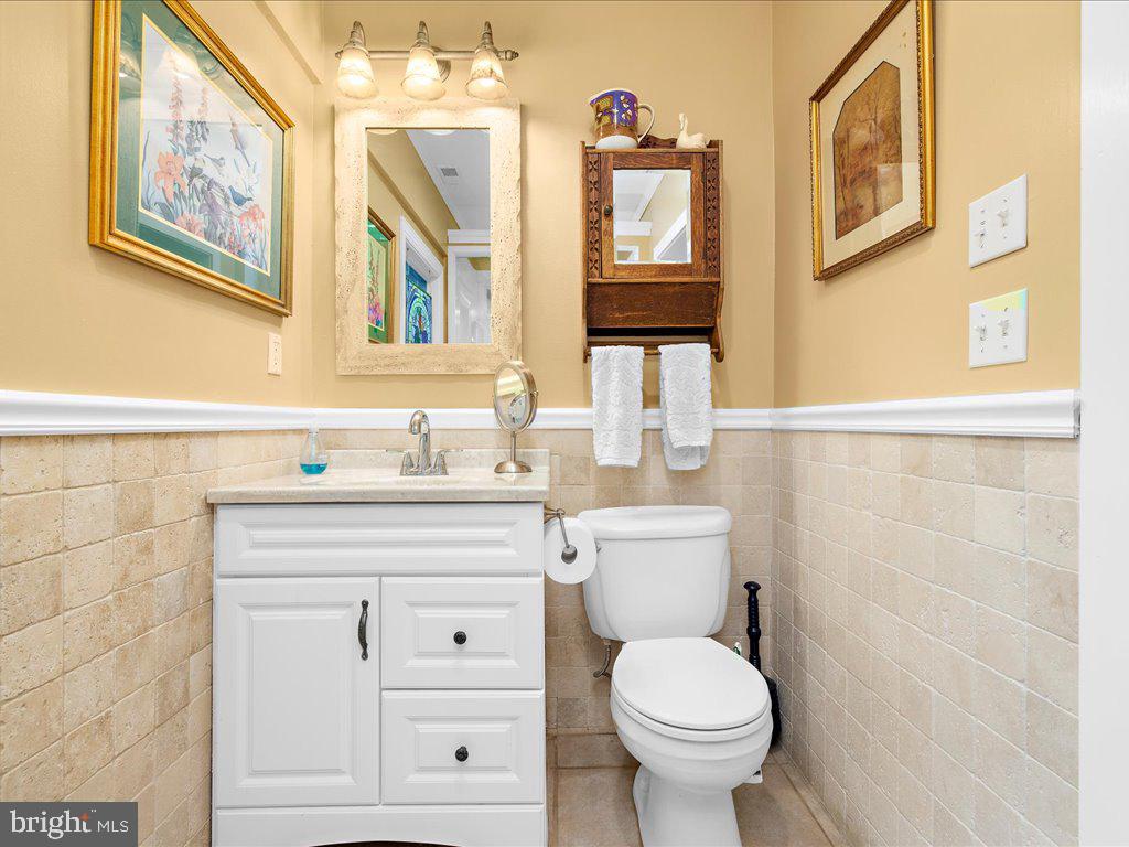720 Southeast Creek Road Church Hill, MD 21623 - Photo 25 of 53 a bathroom with a granite countertop toilet sink and a mirror