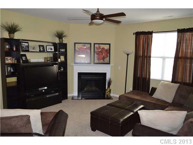 9227 Yellow Oak Road Charlotte, NC 28227 - Photo 3 of 16 a bedroom with a bed a fireplace and a large window