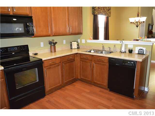 9227 Yellow Oak Road Charlotte, NC 28227 - Photo 7 of 16 a kitchen with a sink stove and cabinets