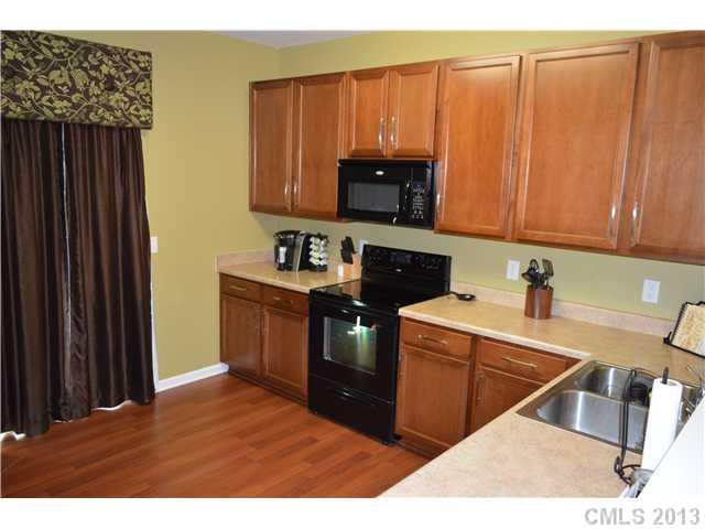 9227 Yellow Oak Road Charlotte, NC 28227 - Photo 8 of 16 a kitchen with a stove a sink and a microwave