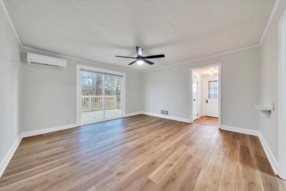 55 Black Feather Trail Ridgeway, VA 24148 - Photo 15 of 35 a view of an empty room with wooden floor and a window