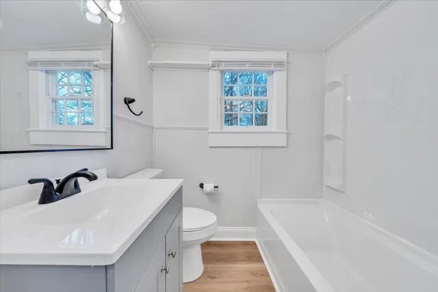 a bathroom with a sink a toilet and bathtub