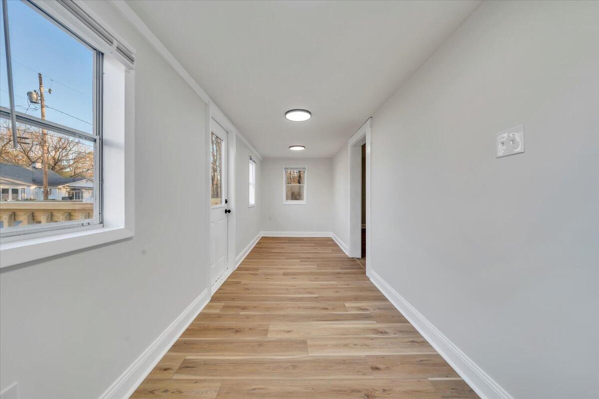 55 Black Feather Trail Ridgeway, VA 24148 - Photo 3 of 35 a view of a hallway with wooden floor and a chandelier