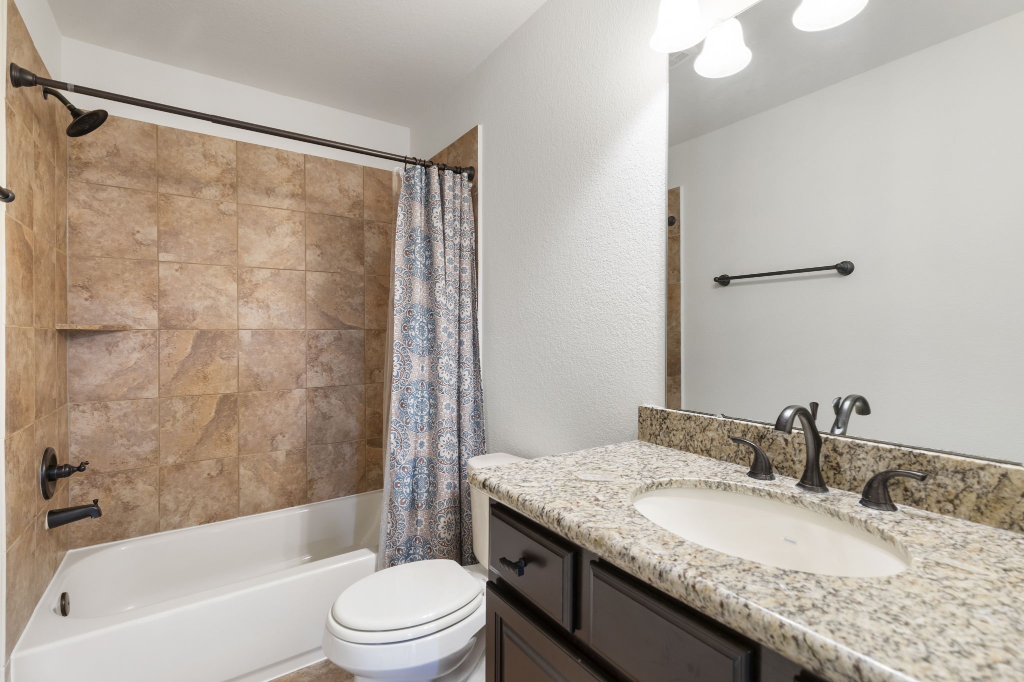 23911 Augusta Falls Lane Spring, TX 77389 - Photo 28 of 40 a bathroom with a granite countertop sink toilet and shower