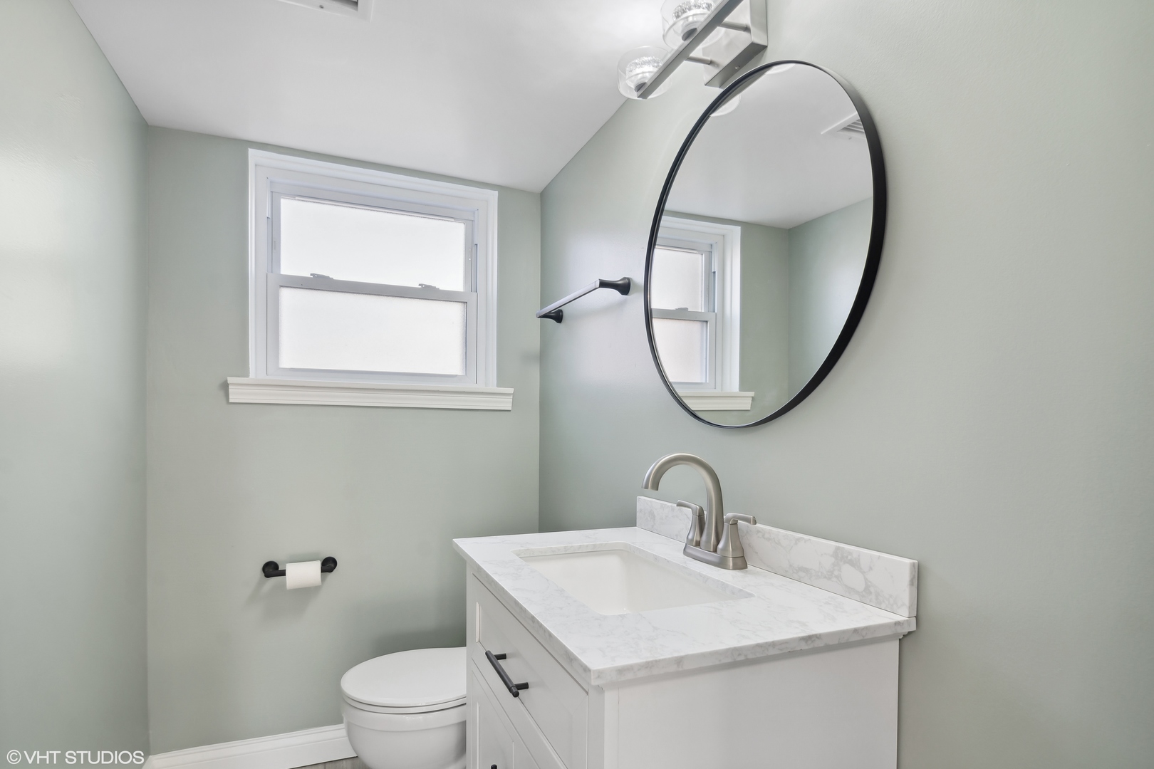 1238 Evergreen Road Homewood, IL 60430 - Photo 9 of 17 a bathroom with a toilet a sink a mirror and a window