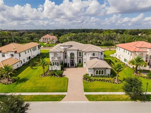 an aerial view of a houses with a swimming pool