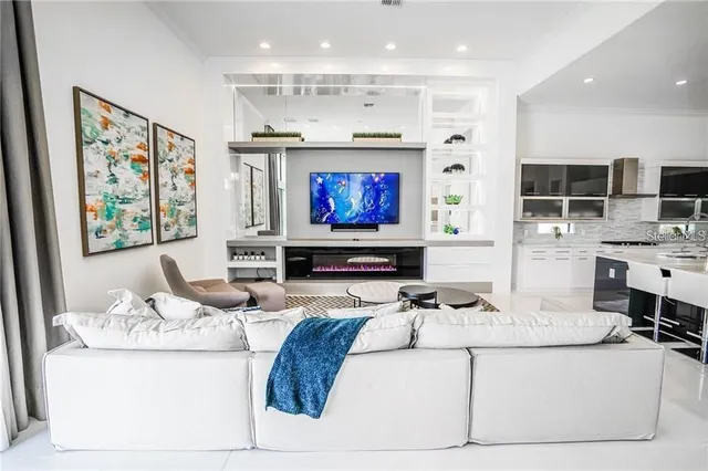 a living room with granite countertop furniture and a flat screen tv