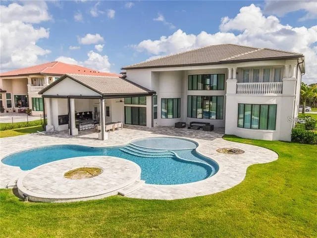 a view of a house with swimming pool and porch