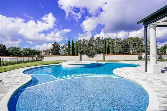 a view of a swimming pool with an outdoor seating