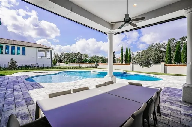 a view of yard with swimming pool and outdoor seating