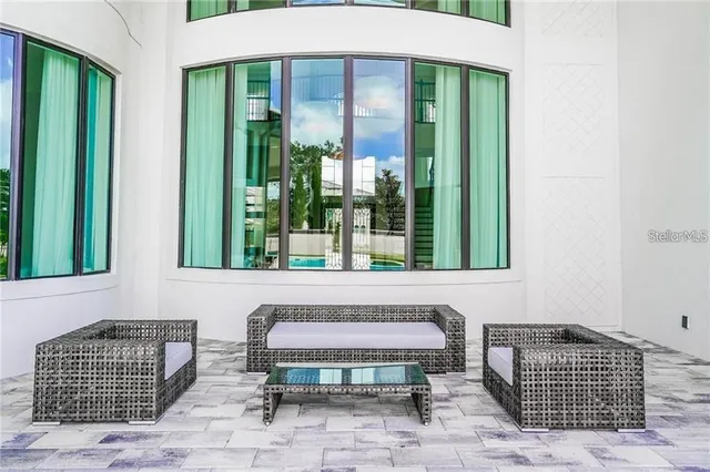 a front view of a house with outdoor seating