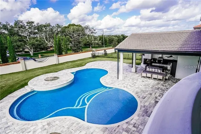 a view of swimming pool with seating space