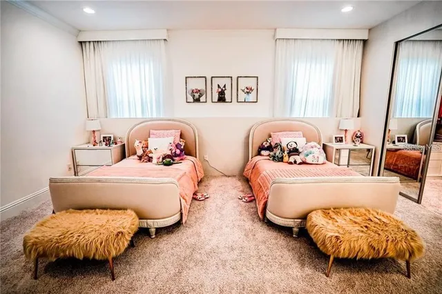 a bedroom with two beds and painting on the wall