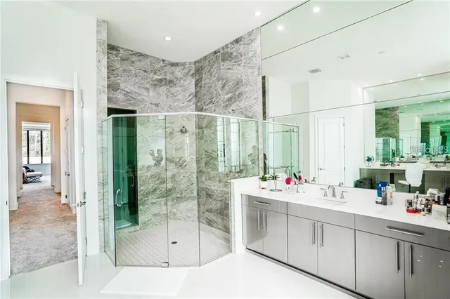 a bathroom with a shower sink and mirror