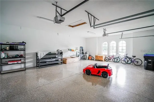 a view of a garage with a white car parked