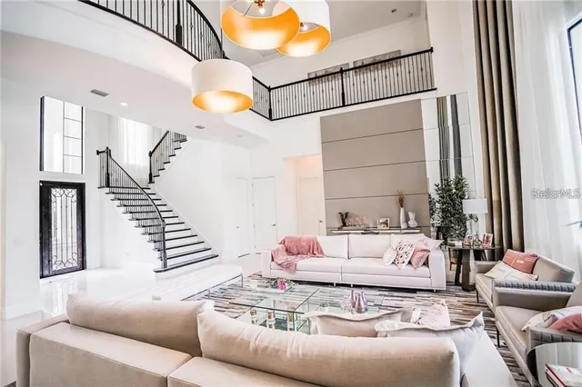 a living room with furniture and stairs