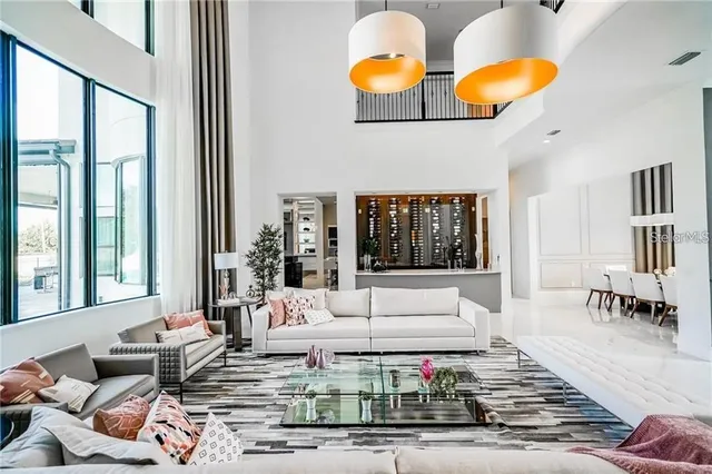 a living room with furniture and large window