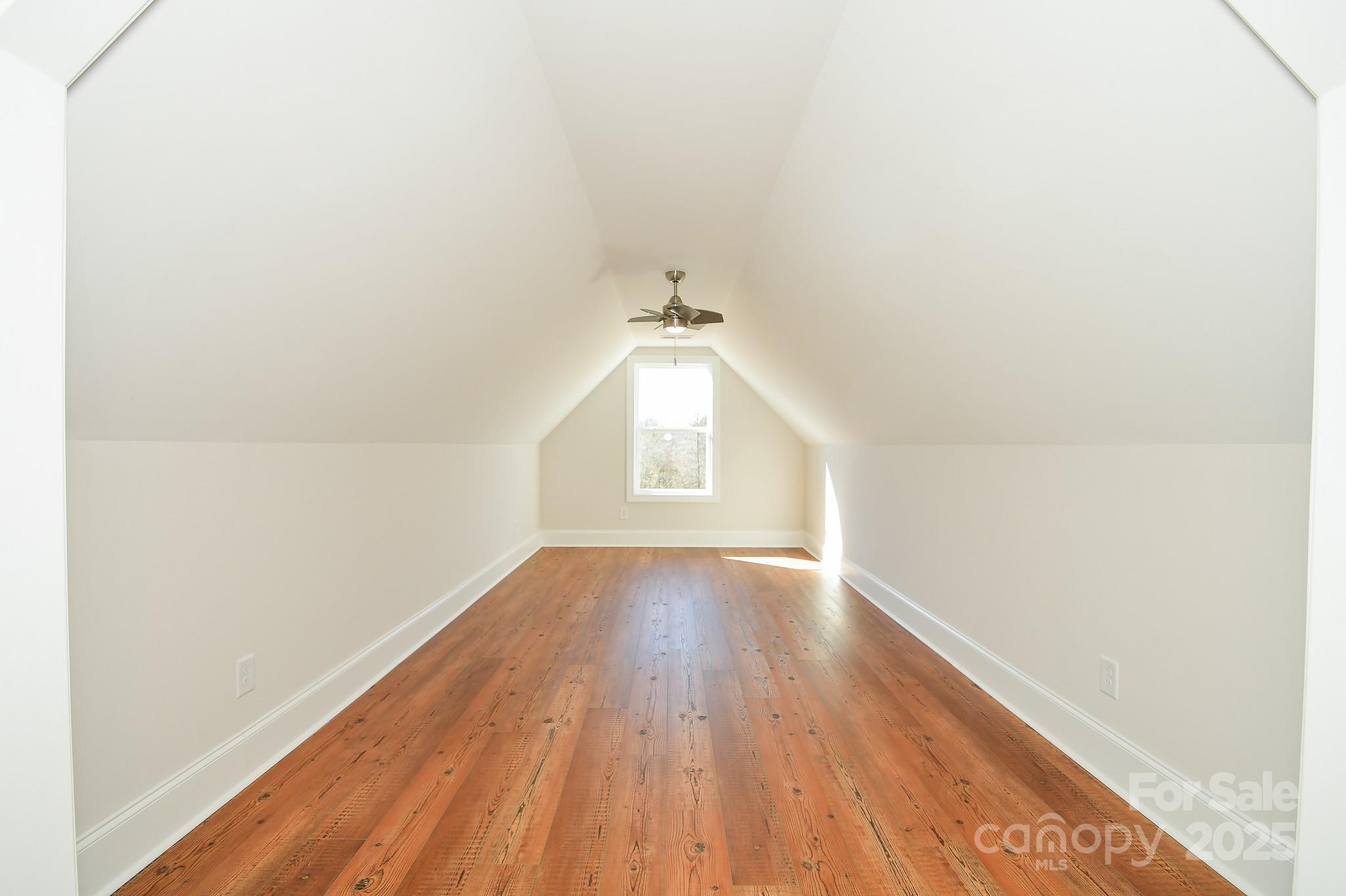 7805 Medlin Road Monroe, NC 28112 - Photo 12 of 13 a view of empty room with wooden floor and fan