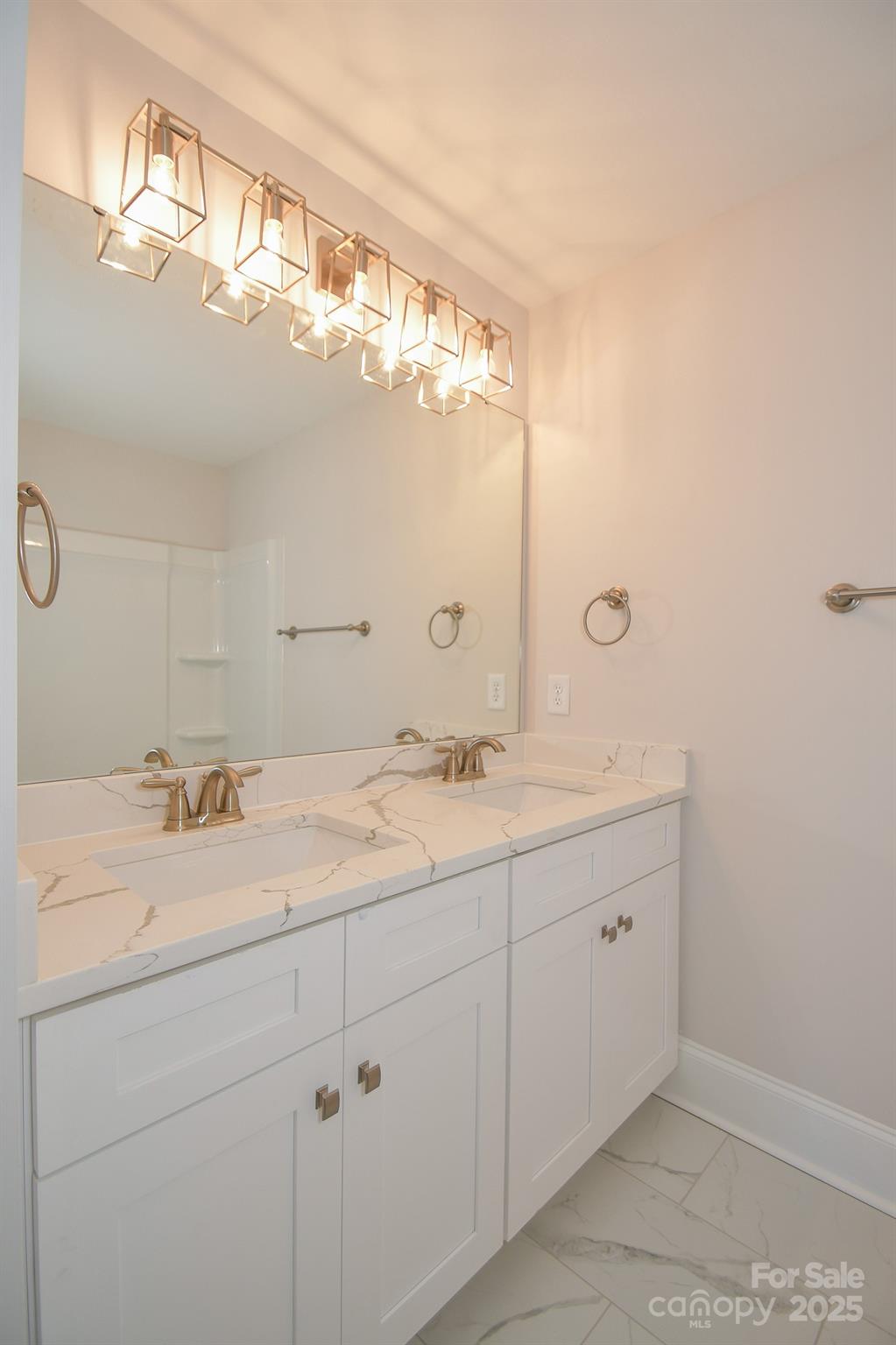 7805 Medlin Road Monroe, NC 28112 - Photo 13 of 13 a bathroom with a double vanity sink and a mirror