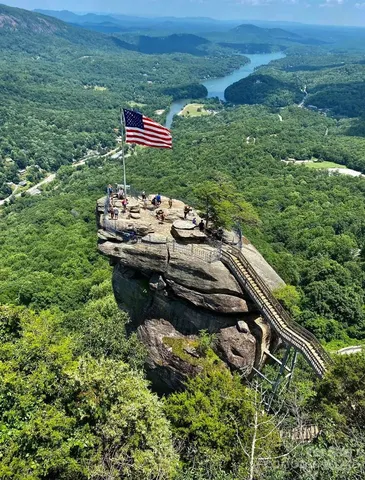 a backyard of a house with a yard and outdoor seating