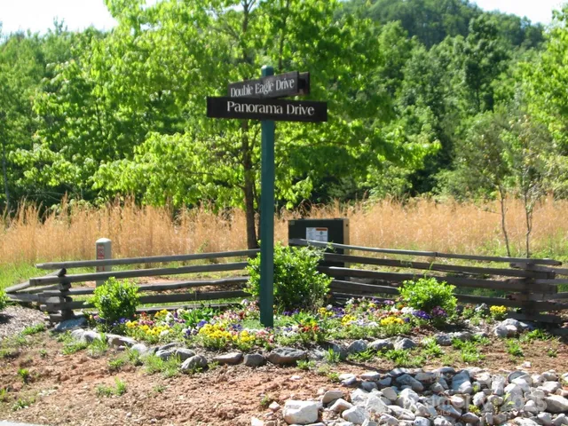 a front view of a house with a yard and a garden