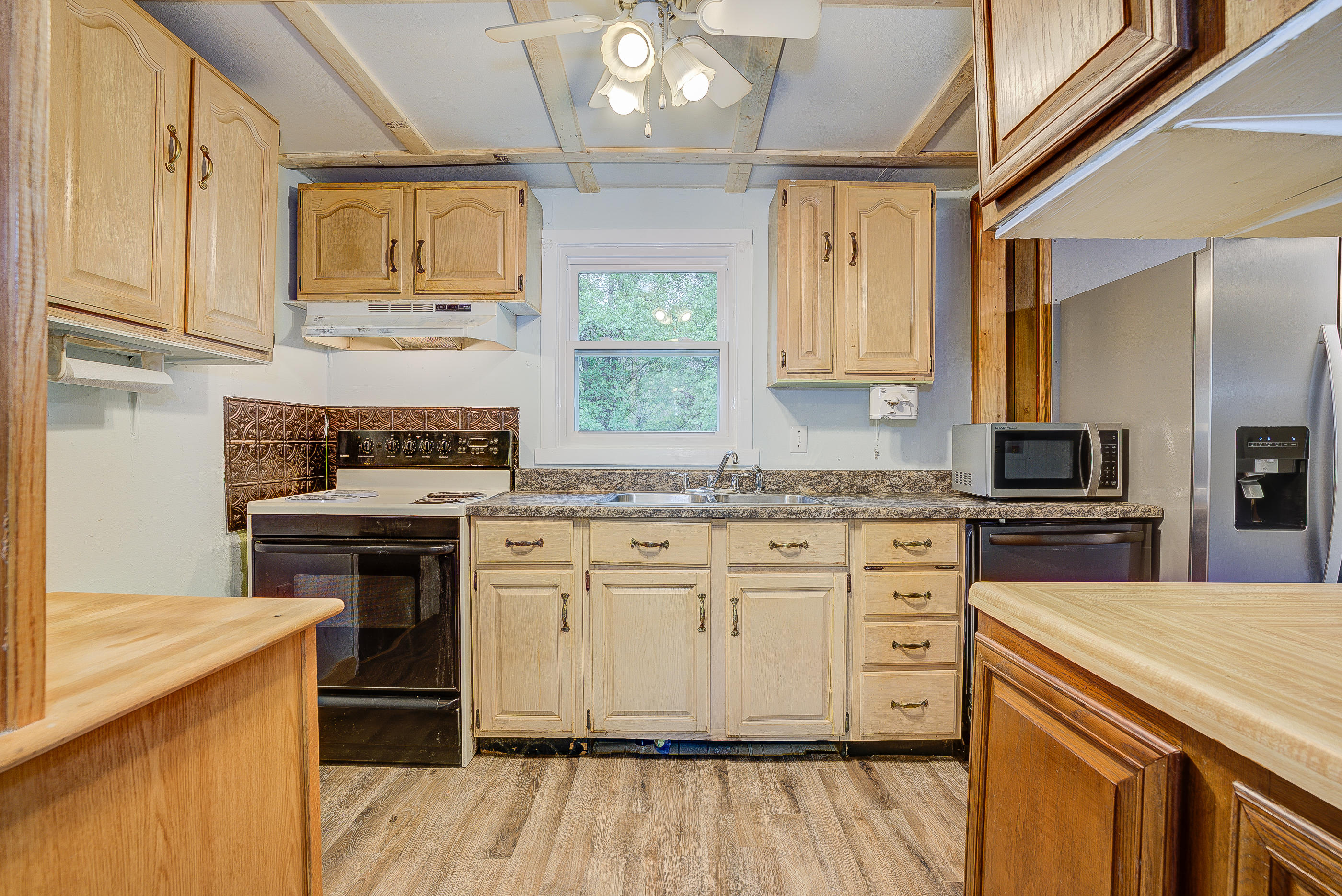 3110 Thomasson Mill Road Goodview, VA 24095 - Photo 14 of 35 a kitchen with stainless steel appliances granite countertop a stove and a sink